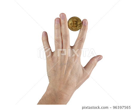 Woman hand holding bitcoin coin between fingers Stock Photo