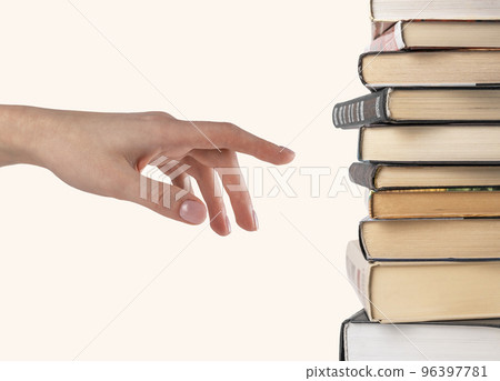 Woman hand selecting or pointing to book from stack isolated on white background. Book choice for reading. Woman hand selecting or pointing to book from stack isolated on white background. Book choice for reading. 96397781