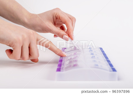 Woman hands opening pills case. Health care concept. Tablets and vitamins storage 96397896