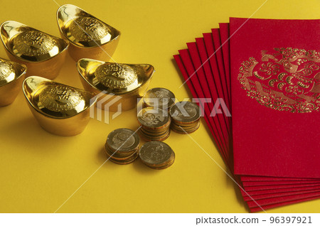 Happy Chinese New Year concept - Red packets with Chinese Golden Ingots and coins on yellow background with customizable space for text 96397921