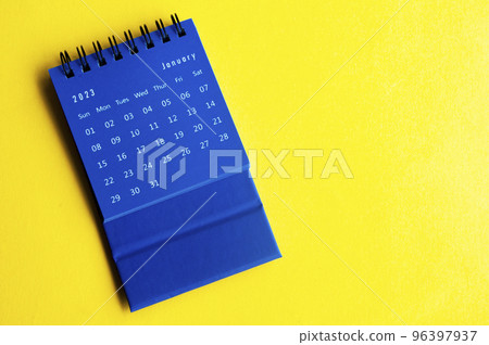 January 2023 blue desk calendar on yellow cover background. Calendar concept. 96397937