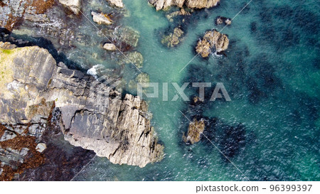 A lot of boulders in the sea water. Coastal cliffs of the North Atlantic. Seaside beautiful nature. Dramatic seascape of the north of Europe. Drone photo. View from above. A lot of boulders in the sea water. Coastal cliffs of the North Atlantic. Seaside beautiful nature. Dramatic seascape of the north of Europe. Drone photo. View from above. 96399397