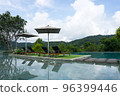 Deck pool chairs beside the swimming pool with mountain background in Chiang Mai, Thailand 96399446