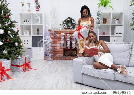 The girl decided to surprise her friend and give her a gift. The girl decided to surprise her friend and give her a gift. 96399885