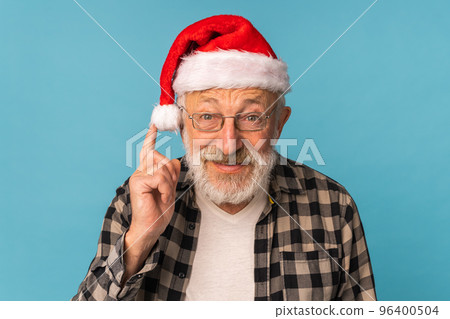 Portrait of happy emotions Santa Claus excited looking at camera on blue background Portrait of happy emotions Santa Claus excited looking at camera on blue background 96400504
