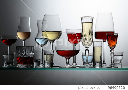 Various alcoholic drinks on a glass shelves. 96400620