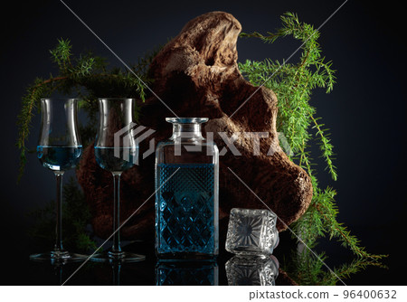 Blue gin and Juniper branches on a black background. 96400632