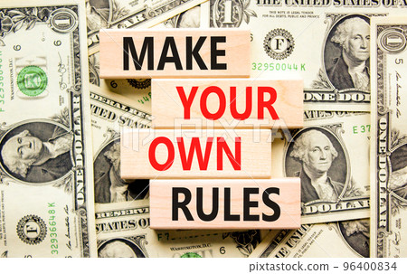 Make your own rules symbol. Concept words Make your own rules on wooden cubes. Beautiful background from dollar bills. Business motivational make your own rules concept. Copy space Make your own rules symbol. Concept words Make your own rules on wooden cubes. Beautiful background from dollar bills. Business motivational make your own rules concept. Copy space 96400834