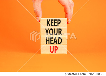 Keep your head up symbol. Concept words Keep your head up on wooden cubes. Beautiful orange table orange background. Businessman hand. Business motivational keep your head up concept. Copy space. 96400836