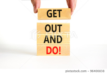 Motivational get out and do symbol. Concept words Get out and do on wooden cubes. Beautiful white table white background. Businessman hand. Business motivational get out and do concept. Copy space. 96400838