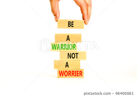 Warrior or worrier symbol. Concept words Be a warrior not a worrier on wooden blocks on a beautiful white table white background. Businessman hand. Business warrior or worrier concept. 96400861
