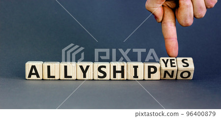 Allyship yes or no symbol. Concept words Allyship yes or Allyship no on wooden cubes. Businessman hand. Beautiful grey table grey background. Business Allyship yes or no concept. Copy space. Allyship yes or no symbol. Concept words Allyship yes or Allyship no on wooden cubes. Businessman hand. Beautiful grey table grey background. Business Allyship yes or no concept. Copy space. 96400879