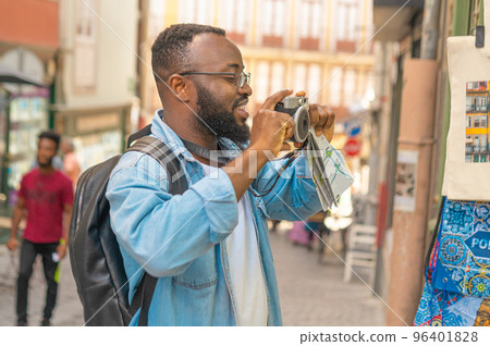 Happy tourist man against european cozy street 96401828