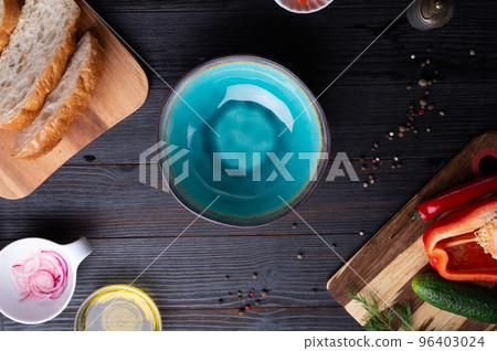 fresh ciabatta bread  with blue bowl and ingredients served at dark wooden table. meditarranean cuisine. flat lay 96403024