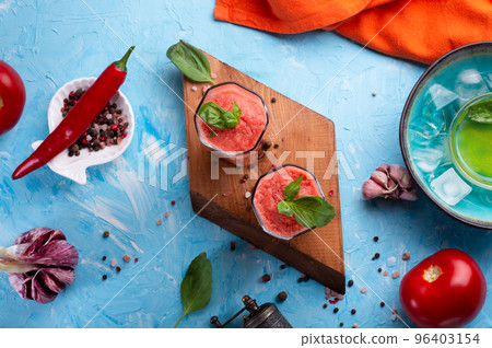 classic spanish raw eating cold soup Gazpacho served  in glasses around blue background. food recipe. healthy concept. 96403154