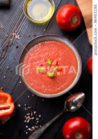 classic spanish raw eating cold soup Gazpacho served at black wooden table. flat lay. food recipe. healthy concept. classic spanish raw eating cold soup Gazpacho served at black wooden table. flat lay. food recipe. healthy concept. 96403198