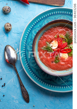 classic spanish raw eating cold soup Gazpacho with quail eggs served at blue  table. flat lay. food recipe. healthy concept. 96403206