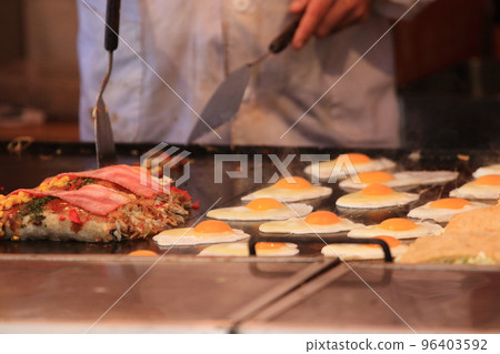 Okonomiyaki from food stalls on festival days Okonomiyaki with plenty of eggs and vegetables Okonomiyaki from food stalls on festival days Okonomiyaki with plenty of eggs and vegetables 96403592