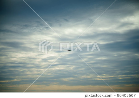 A lone kite dancing in the twilight sky 96403607