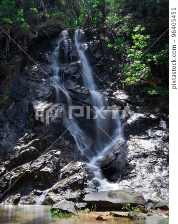 A small waterfall that occurs naturally on the foothills of a low hill in Thailand. 96405451