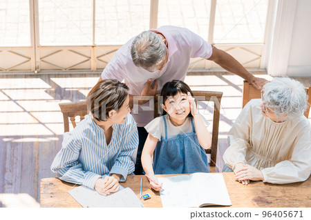 A family watching over an elementary school girl studying A family watching over an elementary school girl studying 96405671