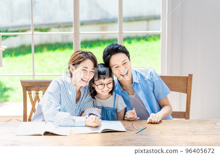A family watching over an elementary school girl studying A family watching over an elementary school girl studying 96405672