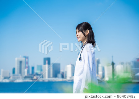 Female doctor walking outside with a smile Female doctor walking outside with a smile 96408482