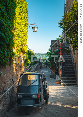 Parked small old vehicle in the narrow street, Italy Parked small old vehicle in the narrow street, Italy 96409044