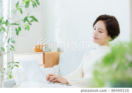 A woman heading to a computer in the living room 96409128
