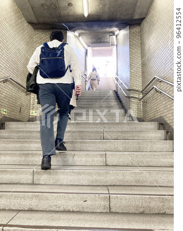 person climbing subway stairs 96412554