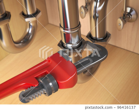 Pllumber using an ajustable wrench to repair a water pipe under the sink. 96416137