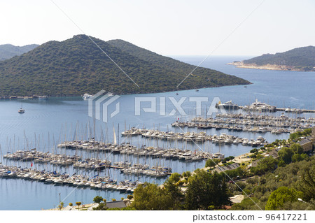Yacht port in the Turkish city of Kas. Beautiful landscape with blue sea and yachts. Tourist attractions of Turkey and the Mediterranean Yacht port in the Turkish city of Kas. Beautiful landscape with blue sea and yachts. Tourist attractions of Turkey and the Mediterranean 96417221