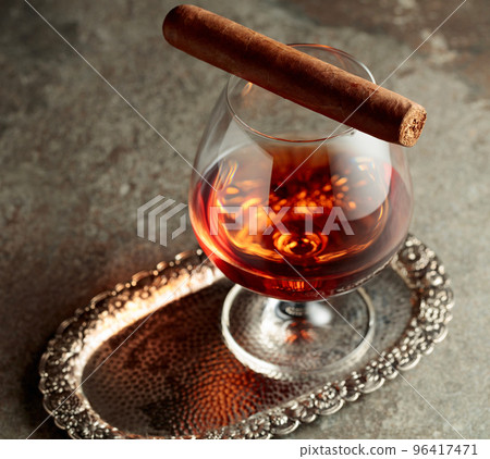 Snifter of brandy and cigar. 96417471
