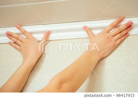 humans hands put a ceiling skirting on the ceiling humans hands put a ceiling skirting on the ceiling 96417915