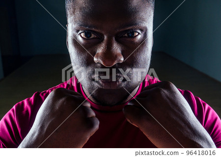 Black african american athletic man running on treadmills idoing exercises on muscle groups push up from the bench gym on black background Black african american athletic man running on treadmills idoing exercises on muscle groups push up from the bench gym on black background 96418016