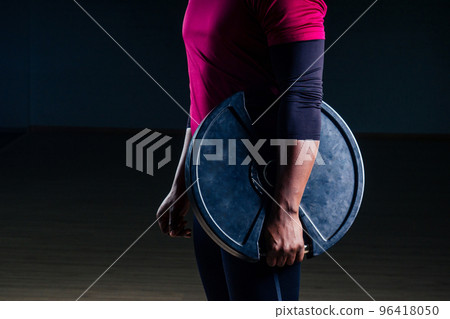 muscular shirtless young african american man in sportswear tire exercising with tyre in gym on a black background in the studio workshop muscular shirtless young african american man in sportswear tire exercising with tyre in gym on a black background in the studio workshop 96418050