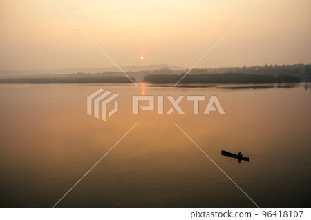 man in boat on the lake at sunset (dawn) man in boat on the lake at sunset (dawn) 96418107