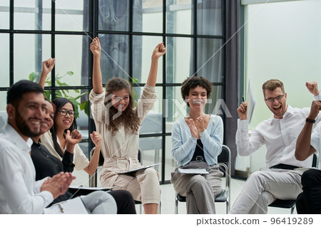 Business people with raised arms during seminar 96419289