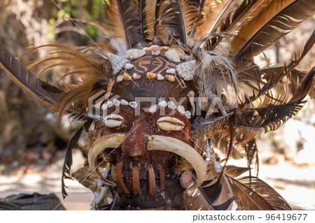 Scary wooden mask of asian totem. Head of ritual sculpture. Carnival decoration. Trible symbol. Ancient religious mask. Culture and religion concept. Scary wooden mask of asian totem. Head of ritual sculpture. Carnival decoration. Trible symbol. Ancient religious mask. Culture and religion concept. 96419677