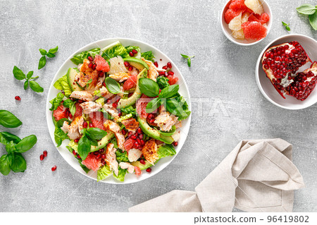 Salad salmon with avocado, grapefruit and pomegranate. Healthy food. Ketogenic, keto or paleo diet lunch bowl. Top view Salad salmon with avocado, grapefruit and pomegranate. Healthy food. Ketogenic, keto or paleo diet lunch bowl. Top view 96419802