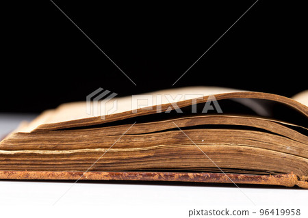 ancient book shot on black background 96419958