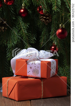 Christmas gift on the background of the Christmas tree close-up Christmas gift on the background of the Christmas tree close-up 96420702