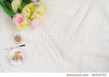 Cosmetic pen and pink yellow tulips on beige desk background. Template for advertising or visualization of blog with copy space, text place. Certificate mockup. Top view. Beauty holiday card. Cosmetic pen and pink yellow tulips on beige desk background. Template for advertising or visualization of blog with copy space, text place. Certificate mockup. Top view. Beauty holiday card. 96420793