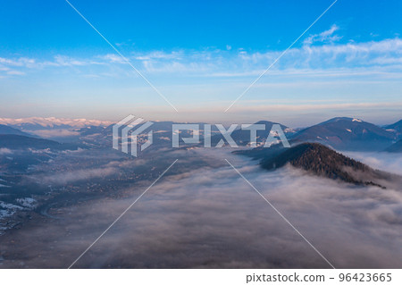Carpathian peaks in the morning in the clouds, top view, drone footage. 96423665