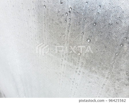 Condensation on window glass frozen in freezing cold Condensation on window glass frozen in freezing cold 96425562