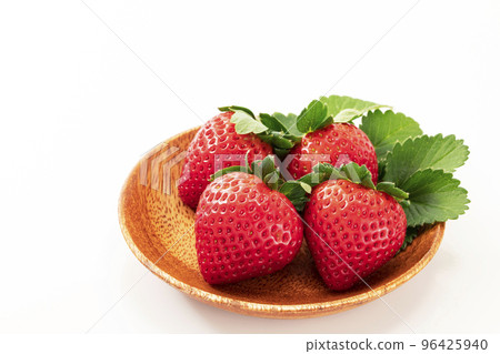 Strawberries on a round wooden plate with a white background Strawberries on a round wooden plate with a white background 96425940