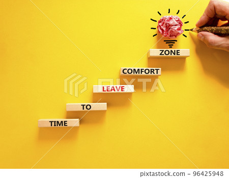 Leave comfort zone symbol. Concept words Time to leave comfort zone on wooden blocks. Businessman hand. Beautiful yellow background. Business time to leave comfort zone concept. Copy space. Leave comfort zone symbol. Concept words Time to leave comfort zone on wooden blocks. Businessman hand. Beautiful yellow background. Business time to leave comfort zone concept. Copy space. 96425948