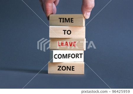 Leave comfort zone symbol. Concept words Time to leave comfort zone on wooden blocks. Businessman hand. Beautiful grey table grey background. Business time to leave comfort zone concept. Copy space. Leave comfort zone symbol. Concept words Time to leave comfort zone on wooden blocks. Businessman hand. Beautiful grey table grey background. Business time to leave comfort zone concept. Copy space. 96425959