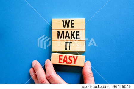 We make it easy symbol. Concept words We make it easy on wooden cubes. Beautiful blue table blue background. Businessman hand. Business motivational we make it easy concept. Copy space. We make it easy symbol. Concept words We make it easy on wooden cubes. Beautiful blue table blue background. Businessman hand. Business motivational we make it easy concept. Copy space. 96426046