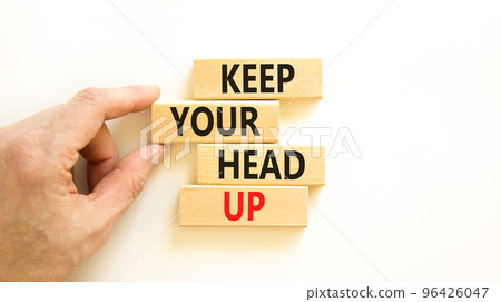 Keep your head up symbol. Concept words Keep your head up on wooden cubes. Beautiful white table white background. Businessman hand. Business motivational keep your head up concept. Copy space. 96426047